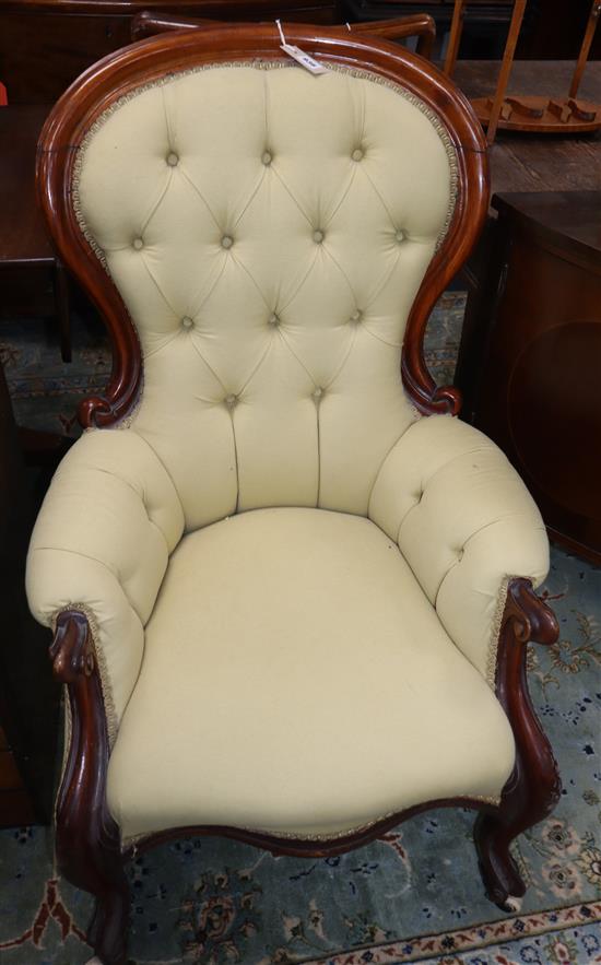 A Victorian walnut deep-buttoned armchair on cabriole legs